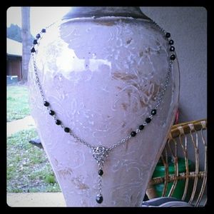 Silver and beaded necklace with a floral pendant